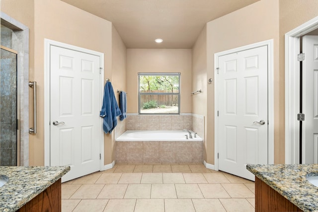 bathroom featuring tile patterned flooring, separate shower and tub, and vanity