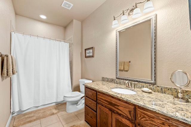 bathroom featuring toilet, tile patterned flooring, and vanity