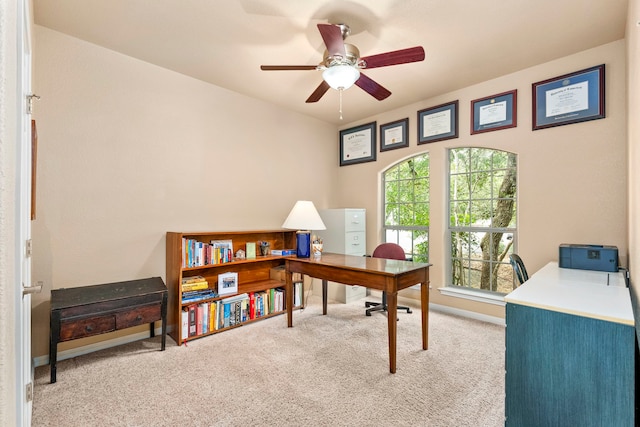 office space with ceiling fan and light carpet