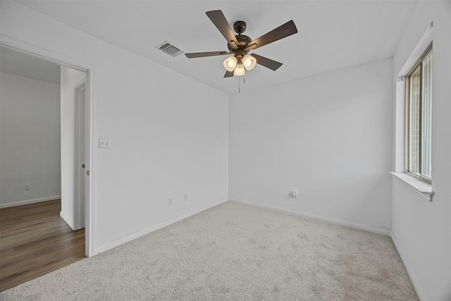 carpeted empty room featuring ceiling fan and a wealth of natural light