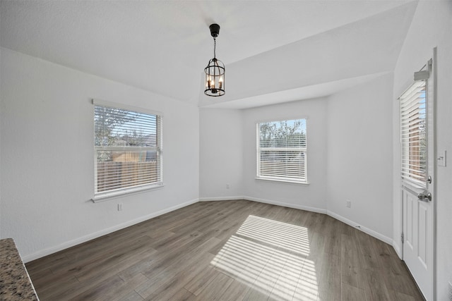 interior space with wood-type flooring and an inviting chandelier