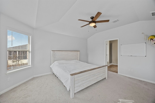 carpeted bedroom with ceiling fan and lofted ceiling