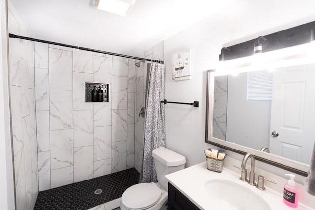 bathroom with toilet, vanity, and a shower with shower curtain