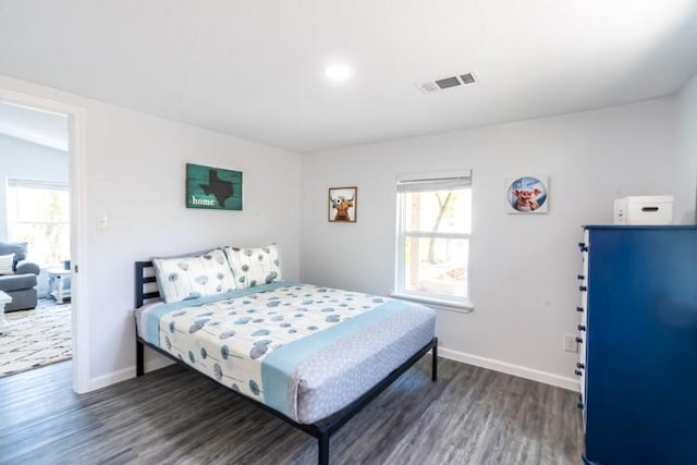 bedroom with dark wood-type flooring