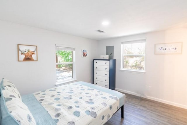 bedroom with dark hardwood / wood-style flooring