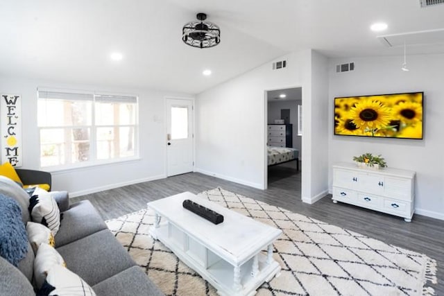 living room featuring vaulted ceiling, plenty of natural light, and dark hardwood / wood-style flooring