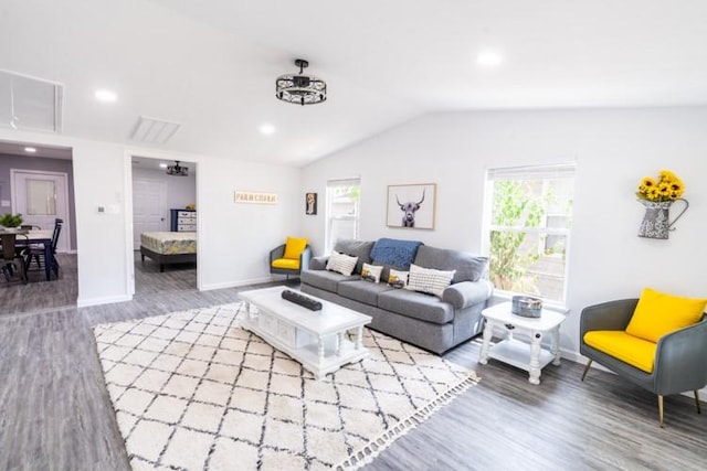 living room with wood-type flooring and vaulted ceiling