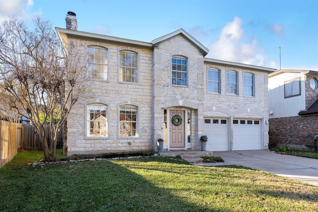 view of front facade with a garage and a front lawn