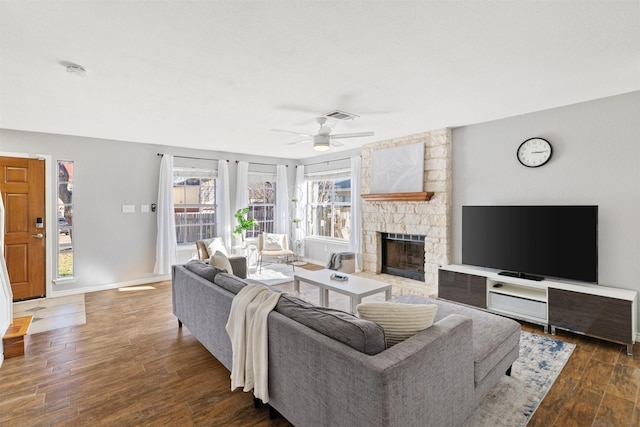 living room with ceiling fan, dark wood-type flooring, and a fireplace