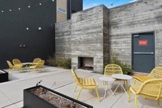 4801 Springdale Rd Unit 2311, Austin, TX 78723 - view of patio / terrace with exterior fireplace