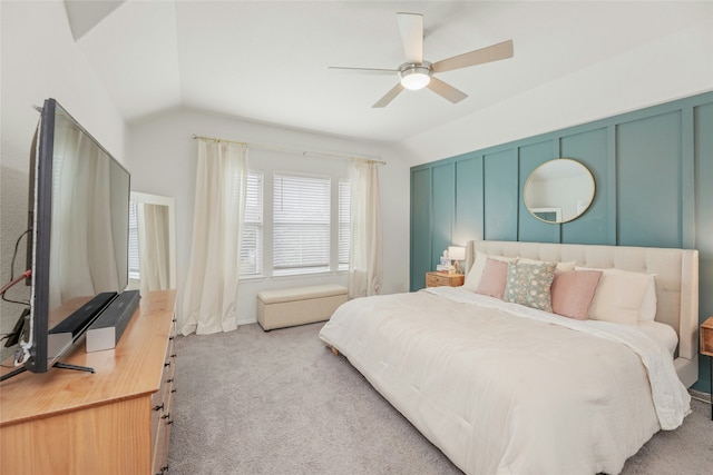 bedroom with ceiling fan, vaulted ceiling, and light colored carpet