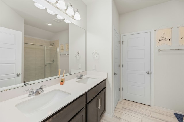 bathroom featuring an enclosed shower and vanity