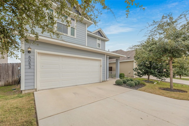 view of front of house with a garage and a front lawn