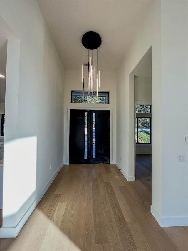 entrance foyer featuring an inviting chandelier and light wood-type flooring