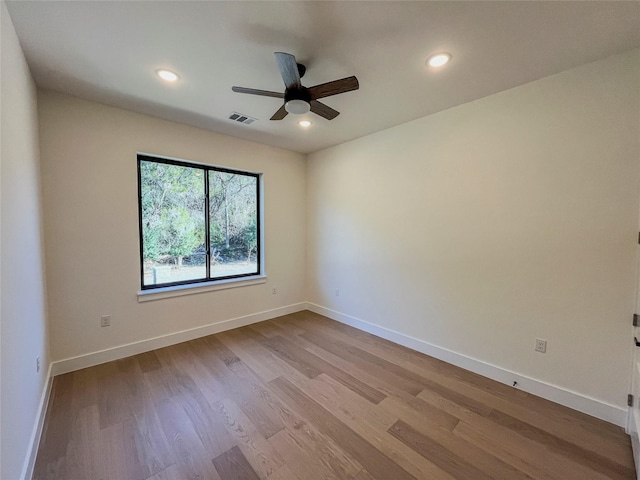 spare room featuring light wood-type flooring and ceiling fan