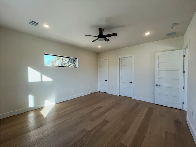 unfurnished bedroom with ceiling fan and dark hardwood / wood-style flooring