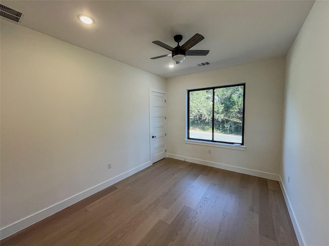 empty room with ceiling fan and hardwood / wood-style flooring