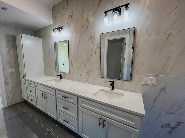 bathroom with tile walls, tile patterned floors, and vanity