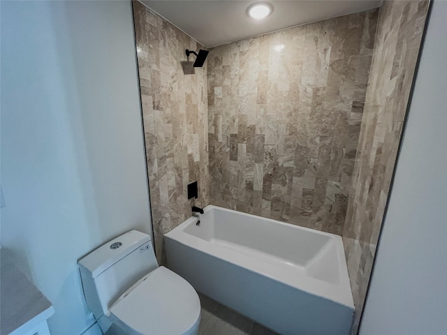 bathroom featuring toilet and tiled shower / bath combo