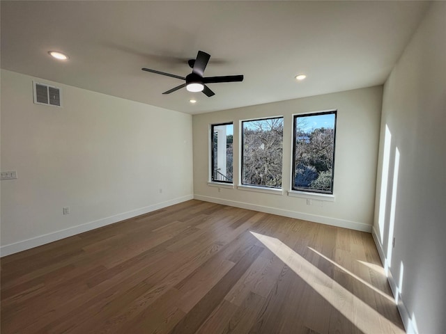 unfurnished room with hardwood / wood-style floors and ceiling fan