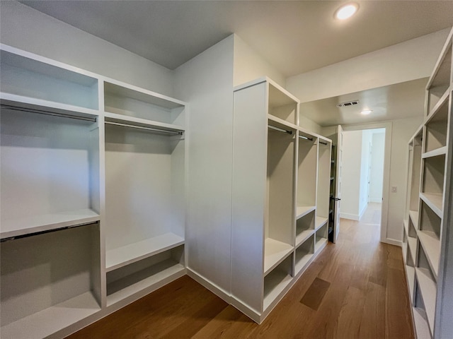 walk in closet featuring dark hardwood / wood-style floors