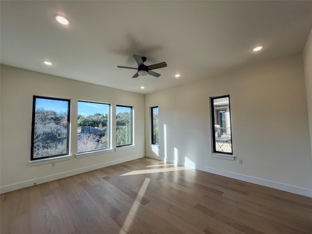 unfurnished room with ceiling fan and light wood-type flooring