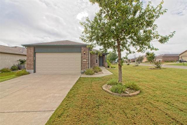 view of front of property with a front yard and a garage