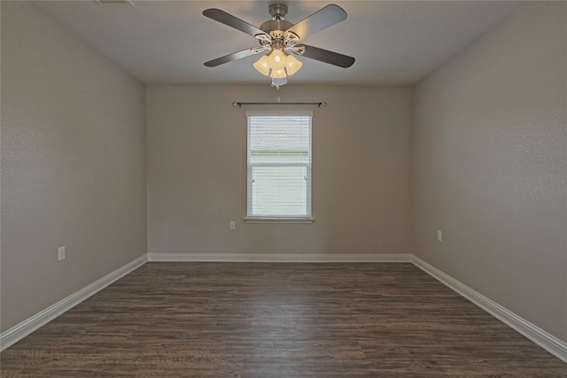 empty room featuring ceiling fan and dark hardwood / wood-style flooring