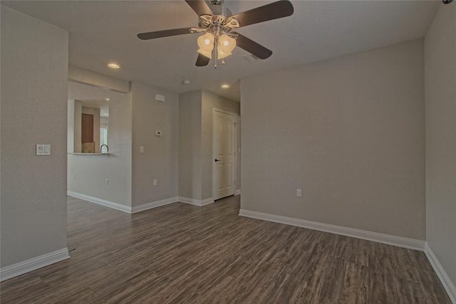 unfurnished room featuring ceiling fan and dark hardwood / wood-style flooring