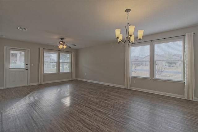 interior space with dark hardwood / wood-style floors, a wealth of natural light, and ceiling fan with notable chandelier