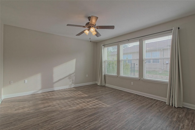 empty room with ceiling fan and dark hardwood / wood-style flooring