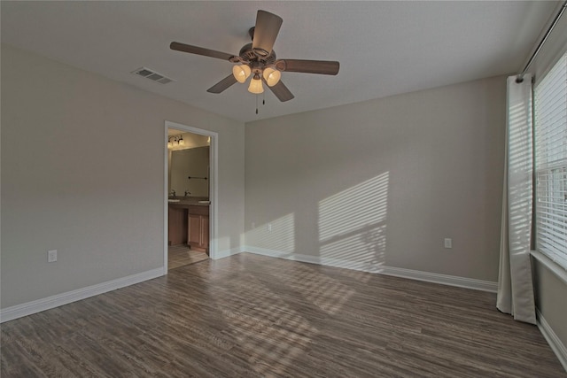 empty room featuring dark hardwood / wood-style flooring and ceiling fan