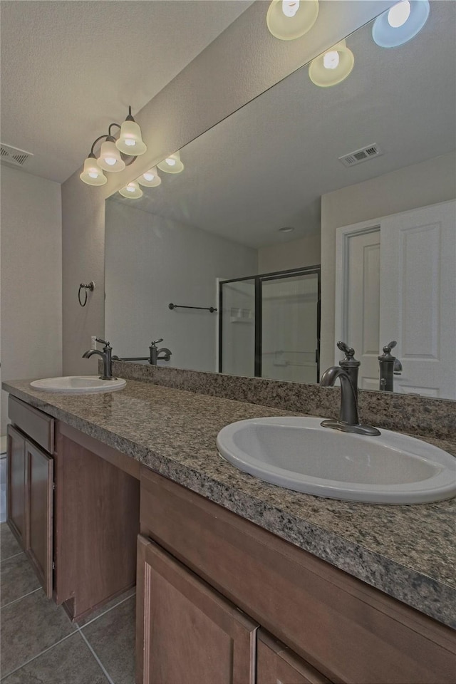 bathroom featuring walk in shower, vanity, and tile patterned floors