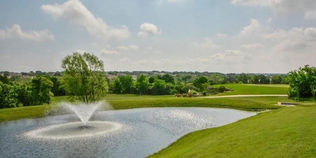 surrounding community featuring a yard and a water view