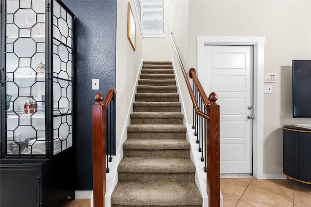 staircase with tile patterned floors