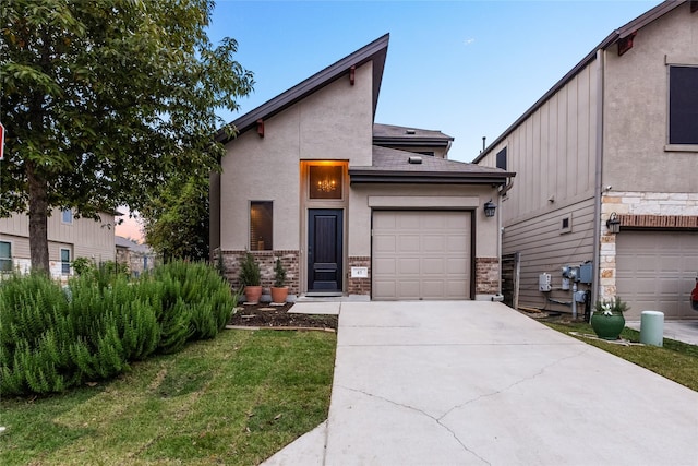 modern home with a garage and a lawn