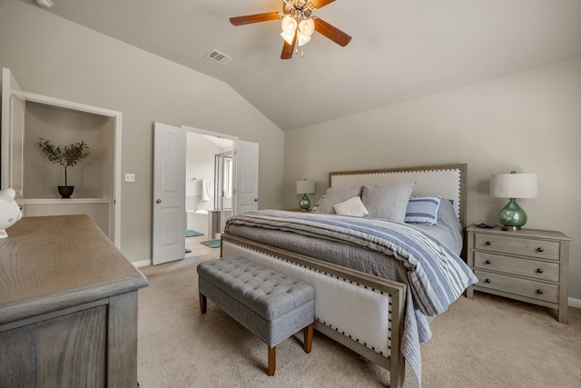 carpeted bedroom with connected bathroom, ceiling fan, and vaulted ceiling