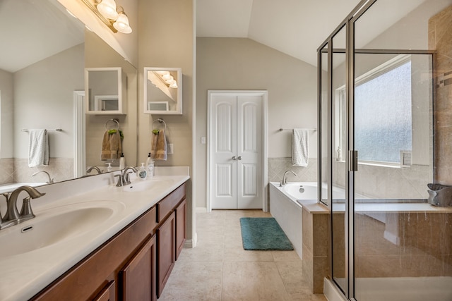 bathroom with tile patterned flooring, vaulted ceiling, vanity, and shower with separate bathtub