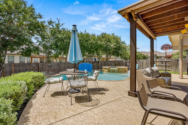 view of patio featuring a pool with hot tub