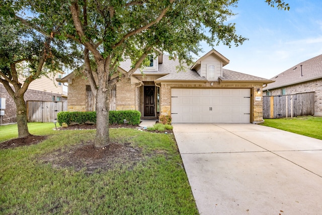 view of front of house featuring a garage and a front lawn