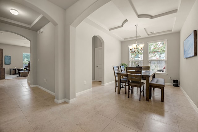 tiled dining room with coffered ceiling and a chandelier