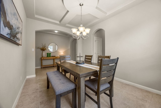 tiled dining space with beamed ceiling, coffered ceiling, and a chandelier