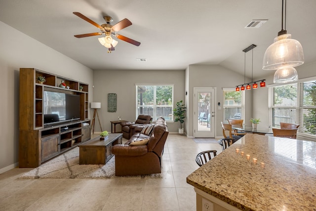 living room with ceiling fan, light tile patterned flooring, and lofted ceiling