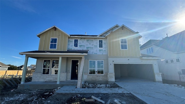 view of front of property with covered porch and a garage