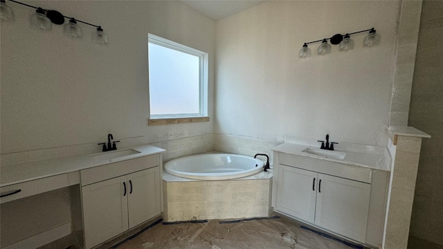 bathroom with vanity and tiled bath