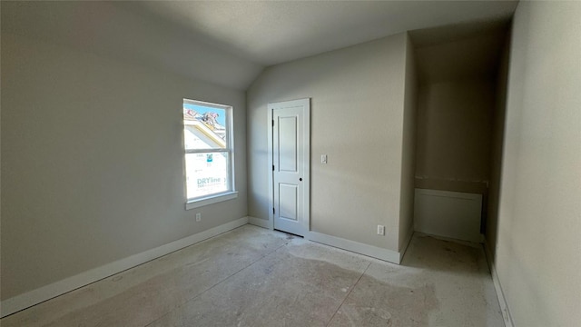 unfurnished bedroom with vaulted ceiling