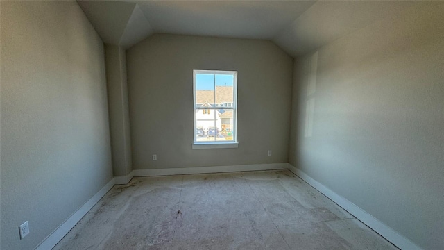 empty room featuring vaulted ceiling