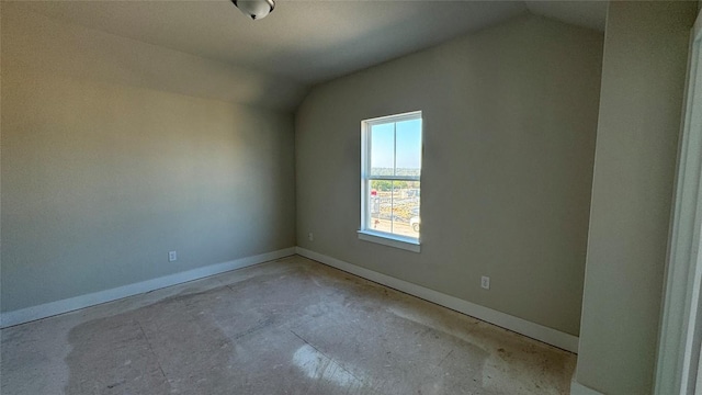 unfurnished room with lofted ceiling