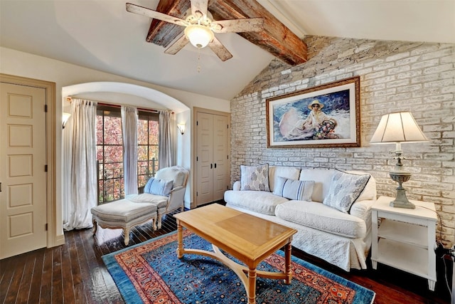 living room with vaulted ceiling with beams, dark wood-type flooring, and ceiling fan