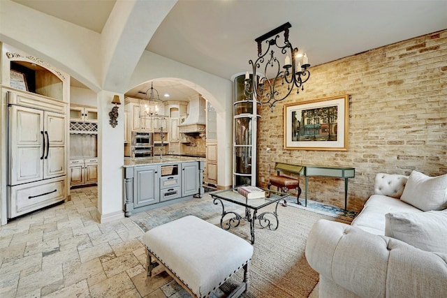 2433 Westlake Dr, Austin, TX 78746 - living room with a chandelier, arched walkways, stone tile flooring, and recessed lighting